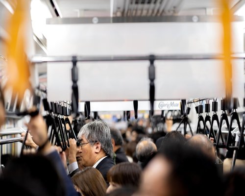 Commuters using smartphones on public transport in the evening